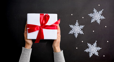 Person holding a Christmast gift box - overhead view flat lay