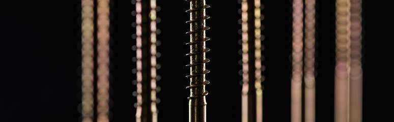 panoramic shot of shiny screw thread isolated on black