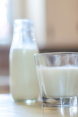 Reptientes with milk on a wooden table and rustic kitchen background. Alternative milk concept. Front view. Horizontal composition