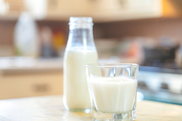Reptientes with milk on a wooden table and rustic kitchen background. Alternative milk concept. Front view. Horizontal composition