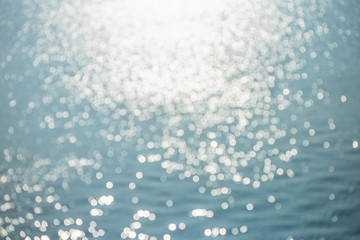 Blur tropical sunset beach with bokeh sun light wave abstract background. Copy space of outdoor summer vacation and travel adventure concept.