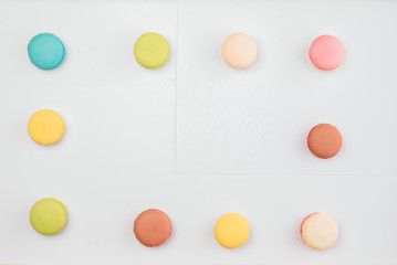 The background is full of various styles of macaron.