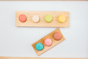 The background is full of various styles of macaron.