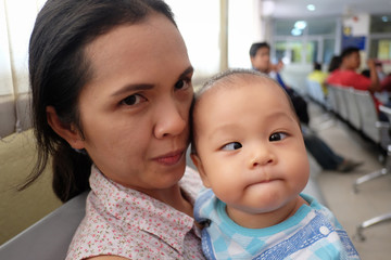 Asian boy with strabismus and mom.