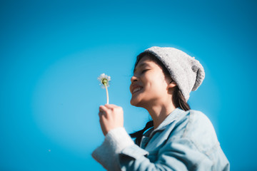 Happy girl playing with Dandelion flower