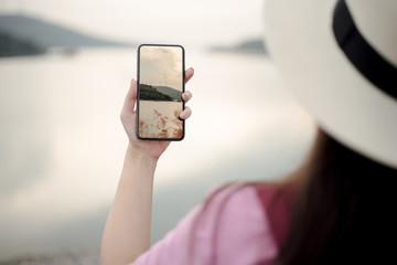 person taking a picture of a mobile phone