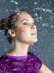 young woman in water  splashes and droplets
