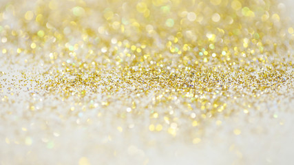 Lights on gold with star bokeh background.Gold celebration background for anniversary, New Year Eve, Christmas, falling coins, wedding or birthday