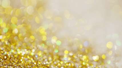 Lights on gold with star bokeh background.Gold celebration background for anniversary, New Year Eve, Christmas, falling coins, wedding or birthday