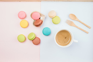 Delicious and colorful macarons placed on a wooden tree decorated with sweet coffee.