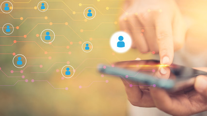 Woman hand hold using smart phone at outdoor park street with people icon and line dot background. Copy space of technology business and travel holiday concept.