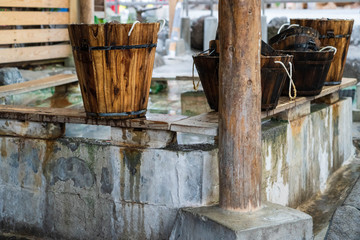Many wooden bucket on seat surrounding hot spring  Kamado feet  Japanese Onsen at Kamado Jigoku cooking pot hell ,Beppu, Oita, Japan.