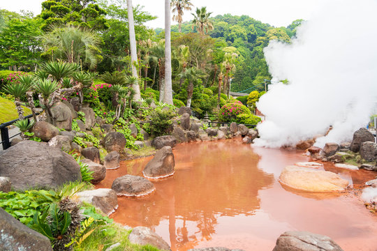 Streaming red hell poud , orange or Red Blood Hell Pond many big rocks surrounding in Beppu, Oita-shi, japan.