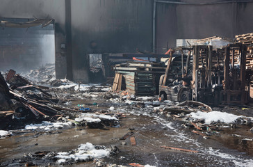 Twisted burnt rubble from a warehouse fire