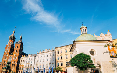 Naklejka premium Church of St. Adalbert (Wojciech) and St. Mary's Basilica at Main Market Square (Rynek Glowny) in Krakow, Poland