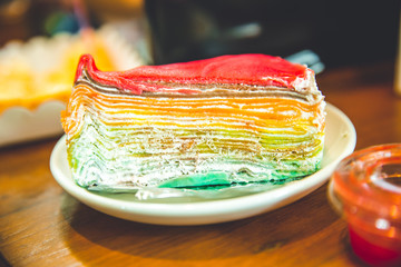 Layer cheesecake colourful rainbow sweet dessert with dipping coating top