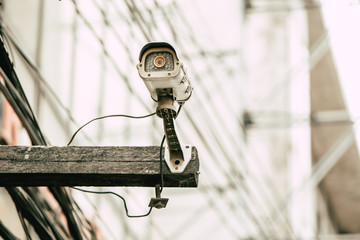 old analog CCTV outdoor device on wood pole