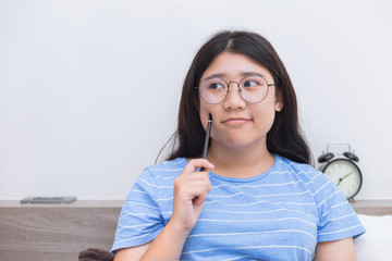 Asian girl teen thinking consider about work plus size nerd wearing glasses people