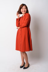 Full body shot of happy beautiful Asian woman smiling