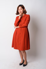 Full body shot of beautiful Asian woman thinking