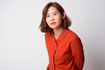 Fototapeta premium Portrait of angry Asian woman with short hair looking upset