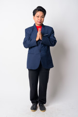 Full body shot of mature Asian businesswoman with Wai as Thai greeting