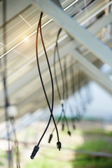 Interior of stand-alone photo voltaic solar system secured on metal rear legs lit by summer sun....