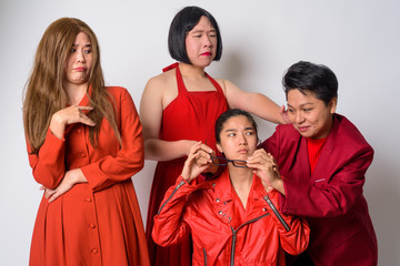 Group of diverse Asian friends in funny struggling situation together