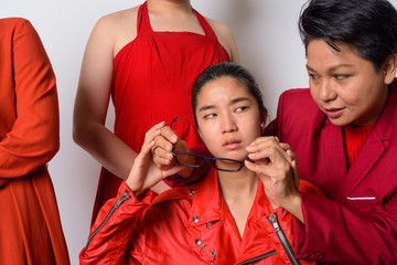 Group of diverse Asian friends in funny struggling situation together