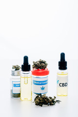 cannabis oil in bottles with lettering cbd and medical cannabis on white background