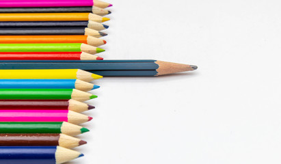 Many colored pencils, arranged in beautiful orderly on a white background