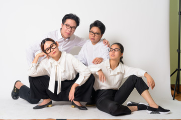 Group shot of Asian business people sitting on the floor together