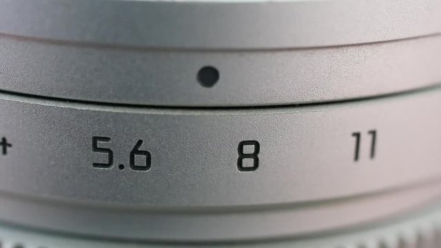 a silver lens that turns a aperture.
