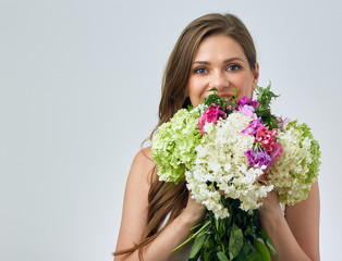 Beautiful smiling girl holding flowers.
