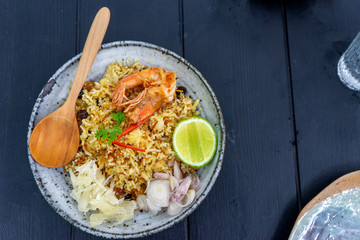 Thai food  Shrimp Fried Rice with wood spoon on wood table.