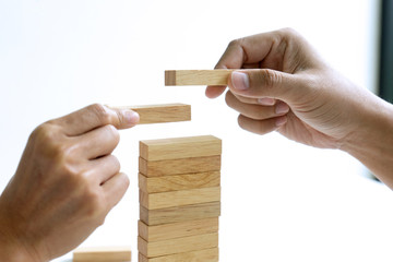 group of  Young businessman try to build wall and tower