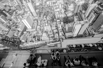 Bangkok, Thailand - September 27 2019: Top view group of people lined up and the city top views. Top view from king power mahanakhon observation deck 314 meters the peak glass tray. unemployed.