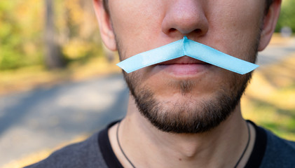 Man with a mustache in the form blue Prostate cancer awareness ribbon. Medicine and healthcare...