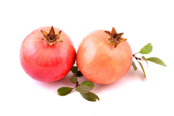 Pomegranate with leaves isolated on white background. Fresh tropical fruits, sweet and healthy. 