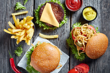 three Cheeseburgers with beef patties, flat lay