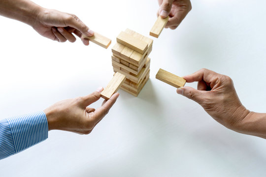 group of  Young businessman try to build wall and tower