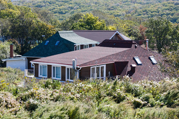 Beautiful country house behind a high fence. Chic cottage in a holiday village.