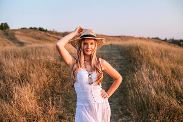 Beautiful woman enjoying nature outdoors at sunset.