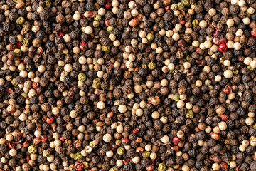 Mixed peppercorns texture. Background with copyspace. Close up. Top view