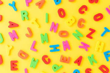 Colourful letters on yellow background - pattern. School background