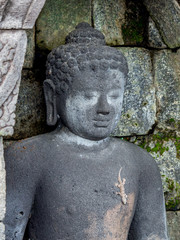 Statue of Buddha with a gecko on it