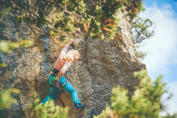 Girl climbing a rock. 