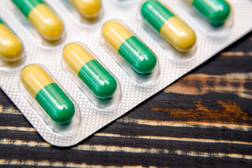 Packaging with pills is on a brown background 