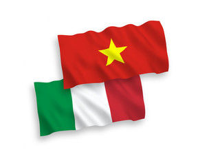 National vector fabric wave flags of Italy and Vietnam isolated on white background. 1 to 2 proportion.