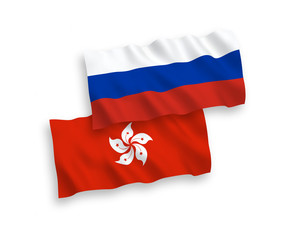 National vector fabric wave flags of Hong Kong and Russia isolated on white background. 1 to 2 proportion.